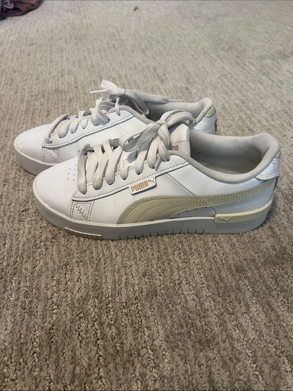 These are white Puma Jada Renew women's sneakers with a platform midsole.